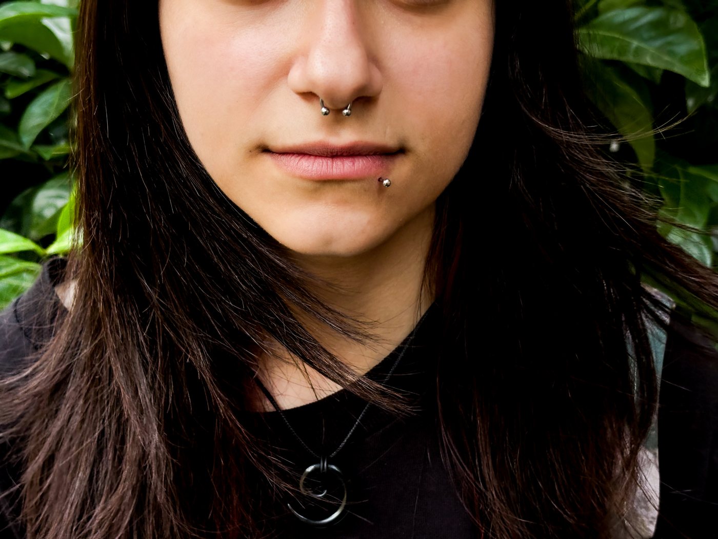 septum ring and side labret, greenery behind