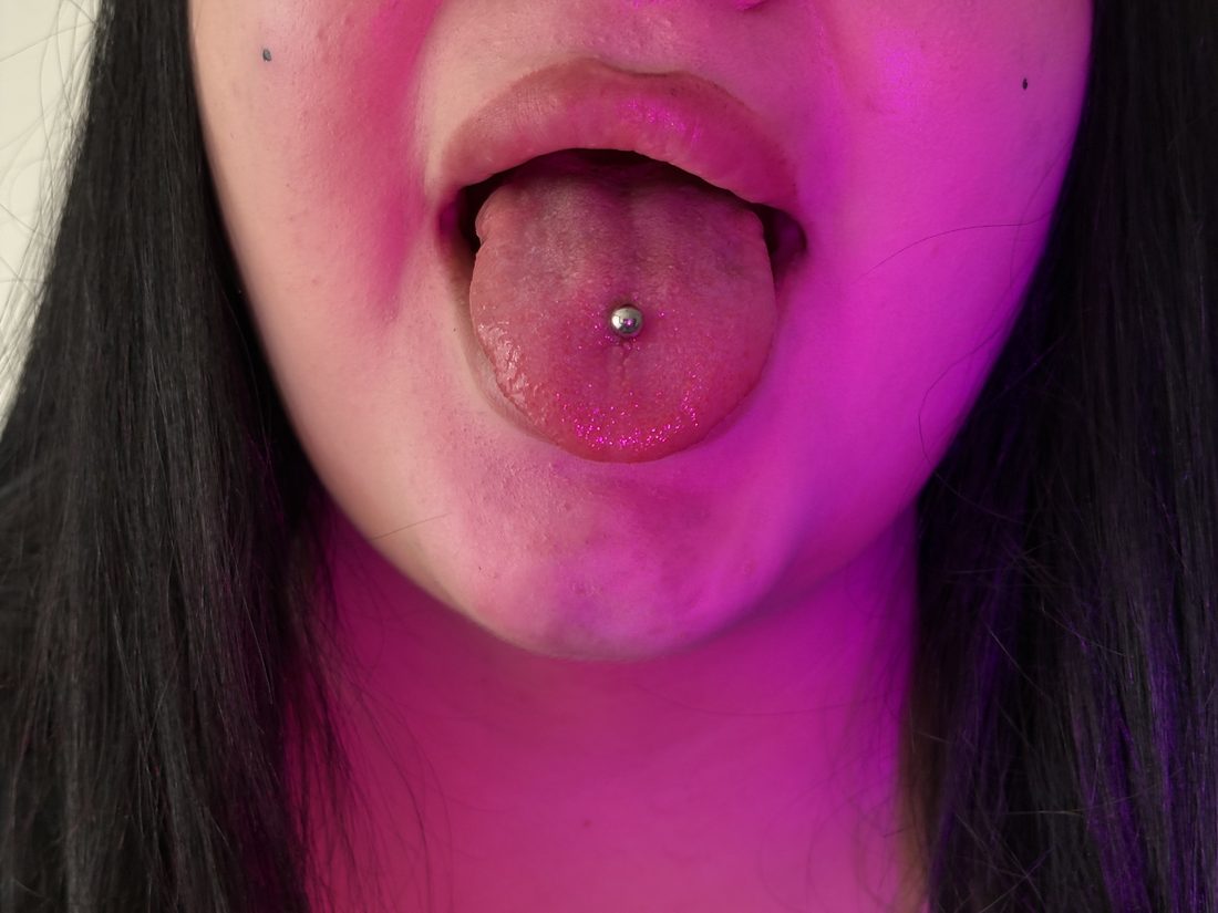 tongue piercing under pink uv light