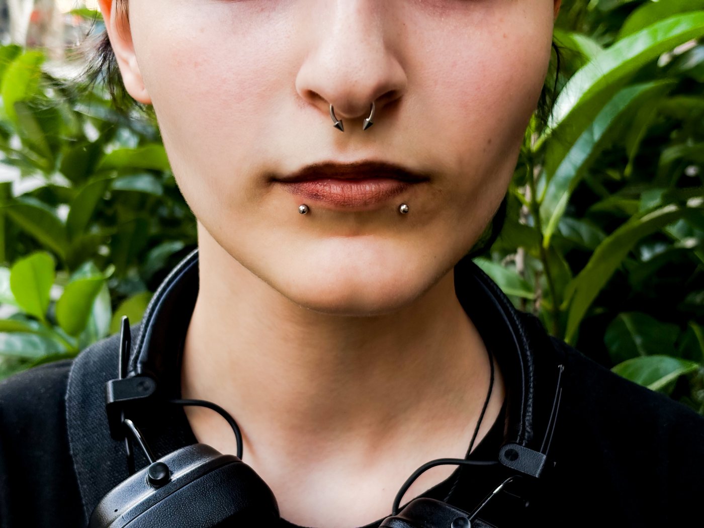 septum and snake bites, greenery behind