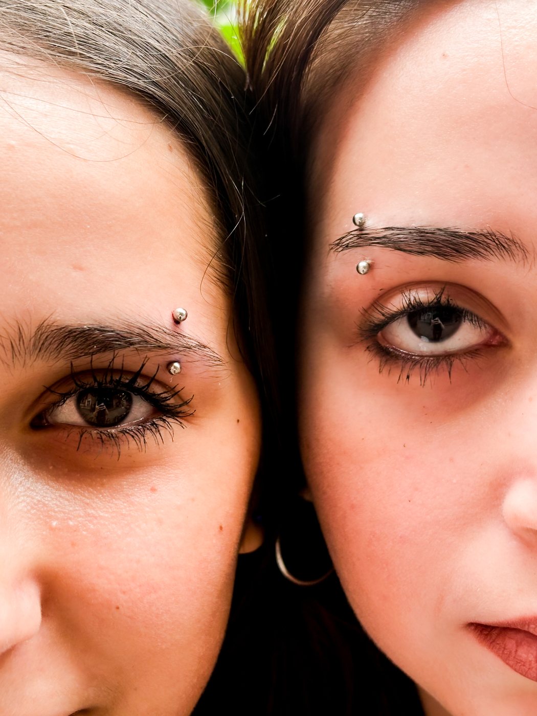 two matching eyebrow piercings