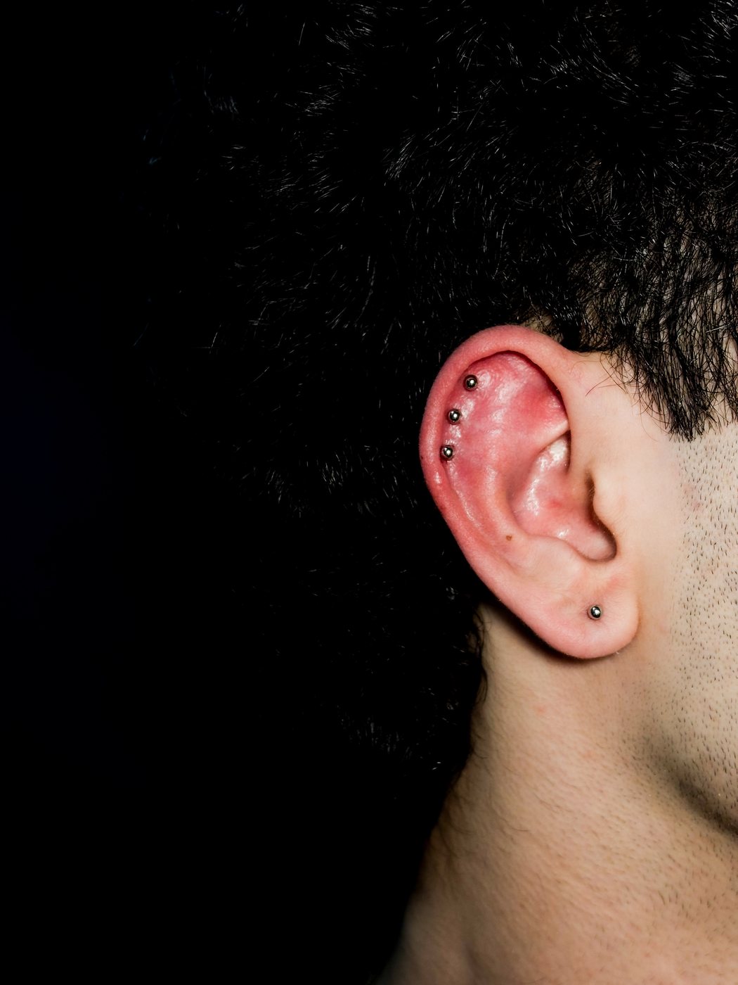 three helix studs in a row and a lobe stud