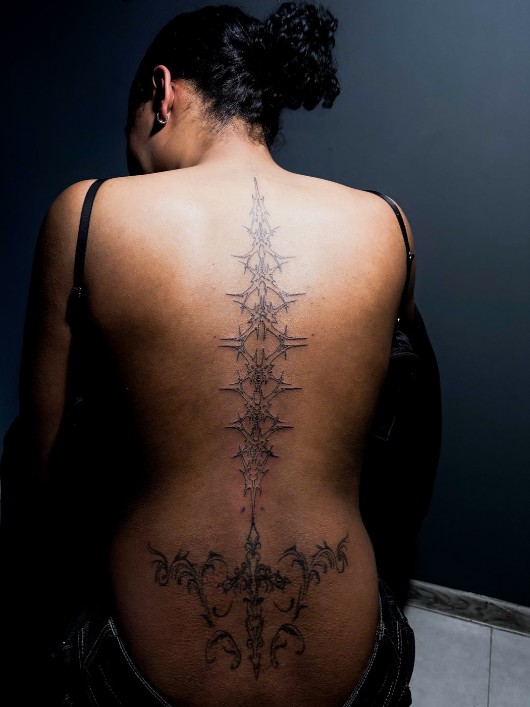 cybersigilism spine piece, seated back view